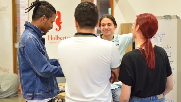 Cuatro personas hablando en la sede de Holberton Medellín